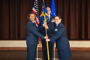 Lt. Col. Alicia Delia, right, takes command of the Geospatial Intelligence Analysis Squadron after receiving the guidon from Col. Zarine E. Malesra, Geospatial and Signatures Intelligence Group commander, at Wright-Patterson Air Force Base, Ohio, July 1, 2026. By accepting the guidon, Delia formally takes charge of the squadron and its vision to be the premier provider for geospatially-based intelligence. (U.S. Air Force photo by Staff Sgt. Kristof J. Rixmann)