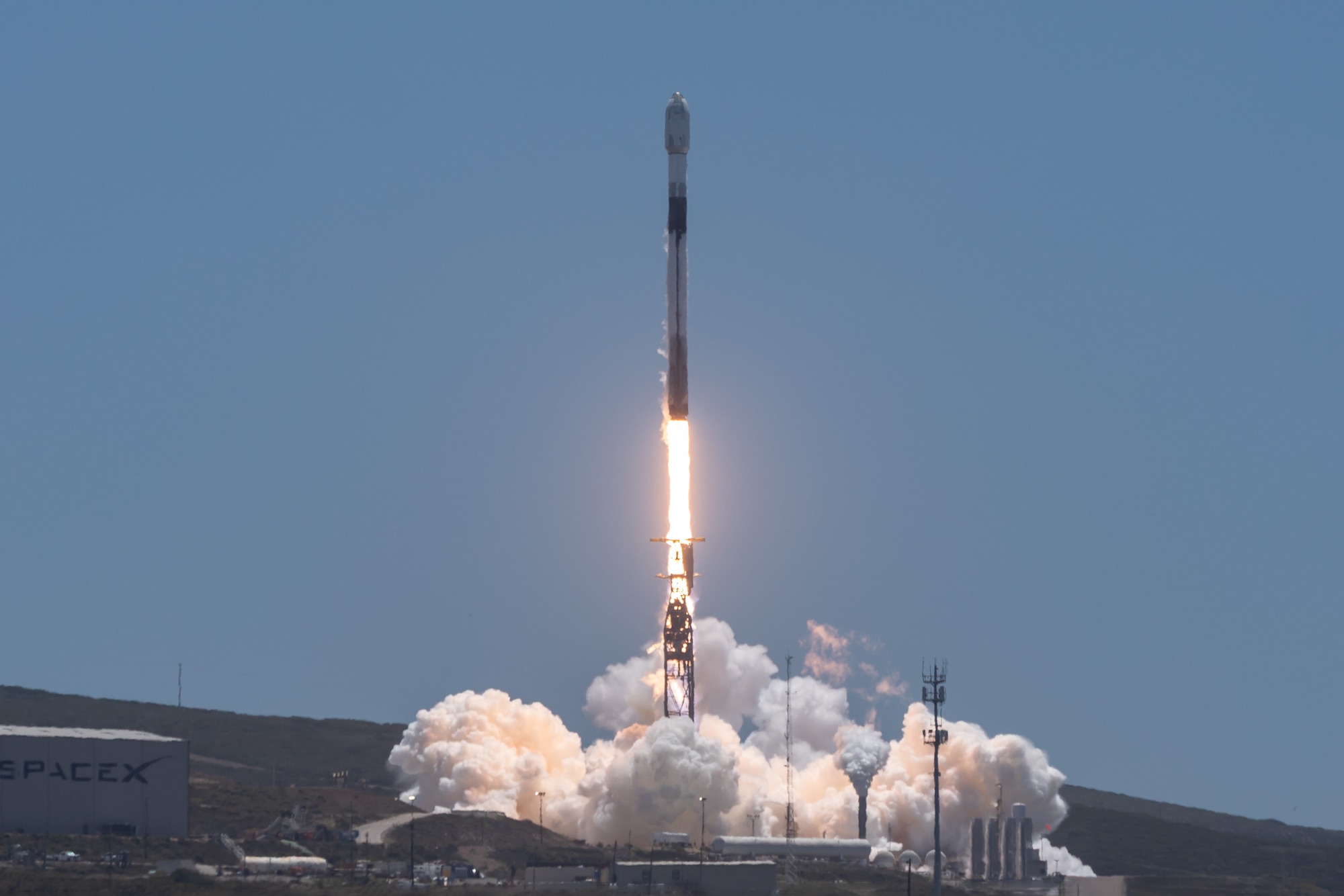 A SpaceX Falcon 9 rocket lifts off in support of a National Security Space Launch (NSSL) mission to deliver 21 Space Development Agency (SDA) data transport Trance 1 (T1) space vehicles to orbit from Space Launch Complex 4 East (SLC-4E), Vandenberg Space Force Base, Calif., on July 19, 2026. This launch was executed in partnership between the SDA and the Space Systems Command (SSC) System Delta 80 (SYD 80), which oversees the NSSL program team that performs independent mission assurance for the launch vehicle, leads the launch campaign, and together with the mission support provided by Space Launch Delta 30 (SLD 30), ensures the safe delivery of this SDA capability to low Earth orbit (LEO).  (Courtesy photo by SpaceX)