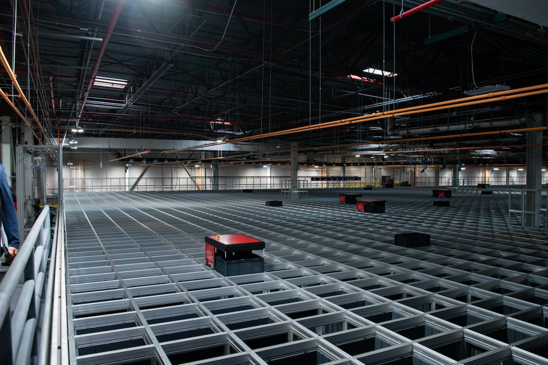 People touring a DLA Distribution warehouse.