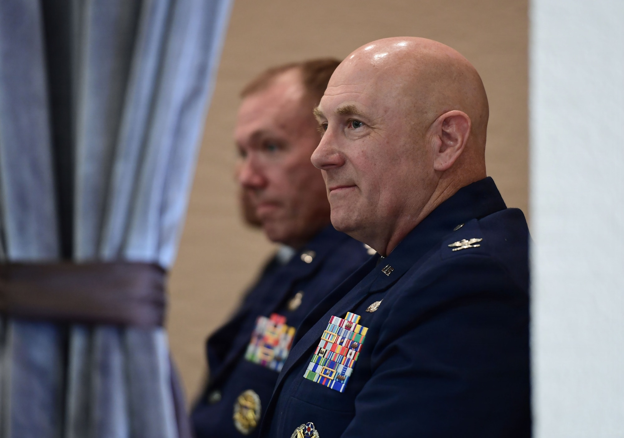 A man in a U.S. Air Force uniform smiles in a photo.