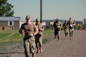 A group of military personnel run.
