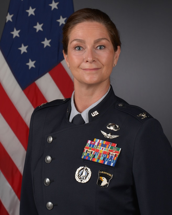 Col. Shubin portrait with flag in uniform