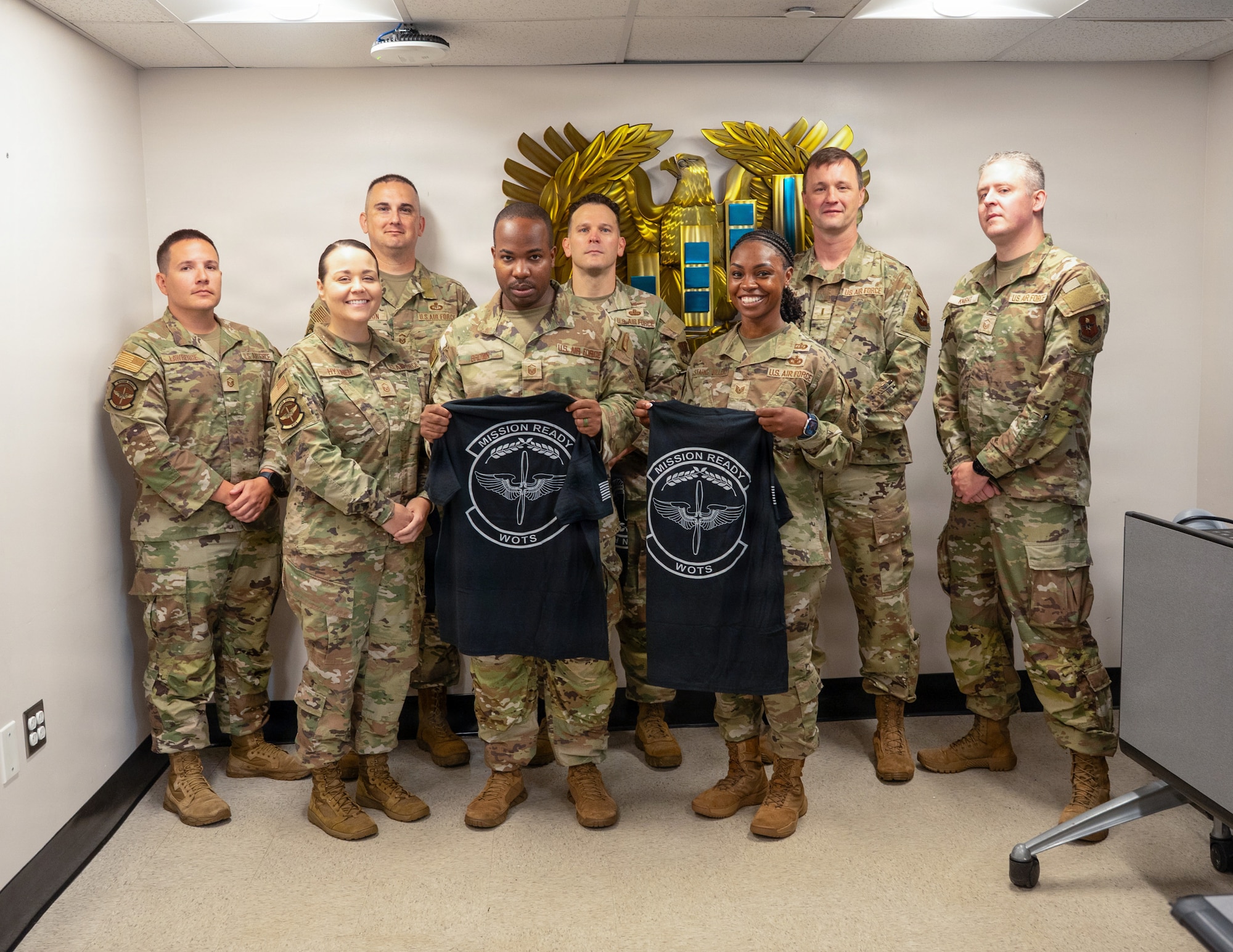 From left, U.S. Air Force Lt. Col. Tanner Allshouse, Warrant Officer Training School (WOTS) commandant; Master Sgt. Kate Hytinen, WOTS instructor; Senior Master Sgt. Kevin Johnson, Chief Warrant Officer 2 Jonathan Miller, Master Sgt. Ernest Brown and Tech. Sgt. Staci Starks-Miller, graduates of the Air Force Train, Advise, Coach Officer program and future WOTS cadre members; Master Sgt. Ryan Knight, WOTS instructor; and Chief Warrant Officer 5 Jason Godwin, WOTS advisor to the commandant, pose for a photo following the program's graduation ceremony at Maxwell Air Force Base, Alabama, July 15, 2026.