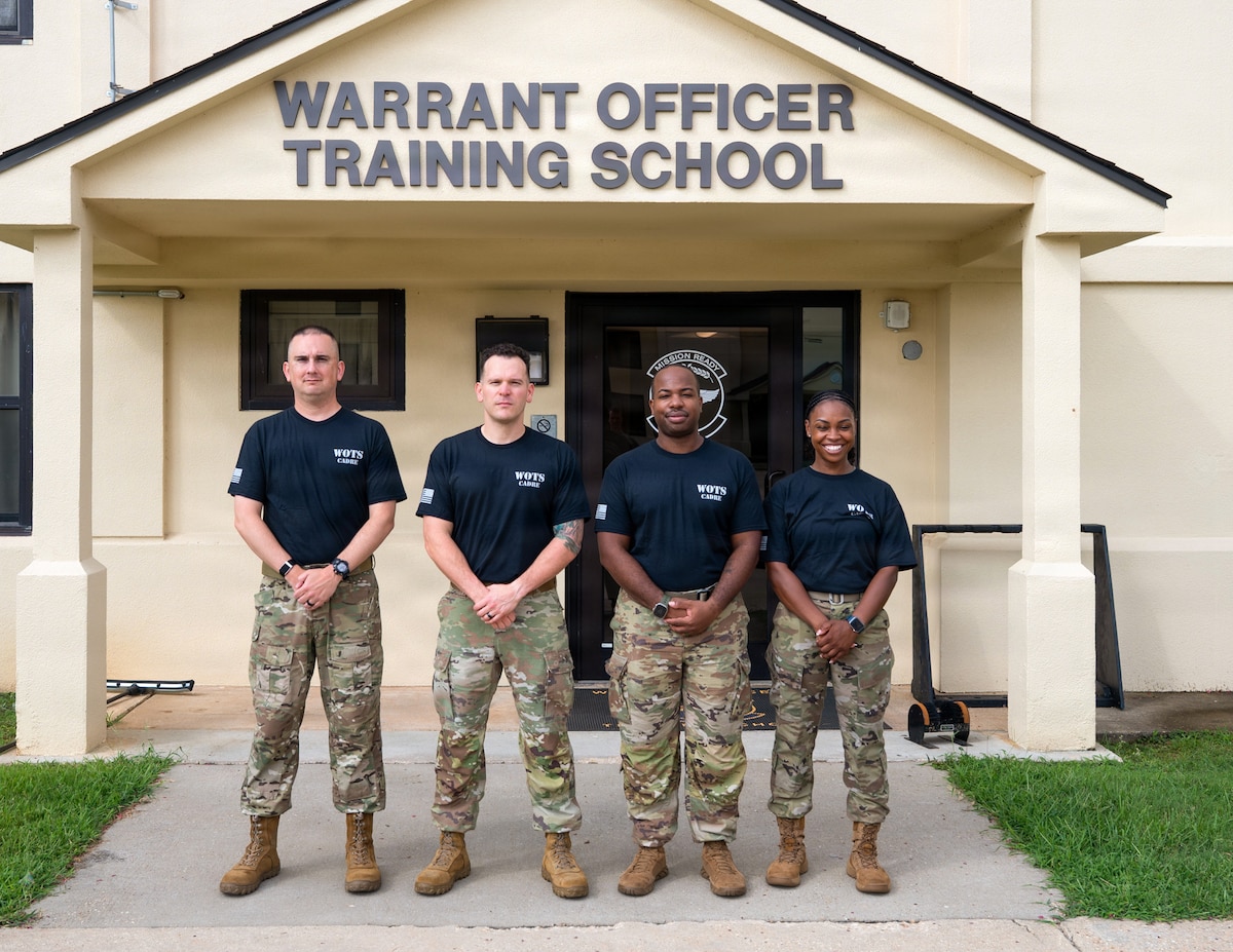 U.S. Air Force Senior Master Sgt. Kevin Johnson, Chief Warrant Officer 2 Jonathan Miller, Master Sgt. Ernest Brown and Tech. Sgt. Staci Starks-Miller, graduates of the Air Force Train, Advise, Coach Officer program and future Warrant Officer Training School cadre members, pose for a photo following their graduation at Maxwell Air Force Base, Alabama, July 15, 2026.