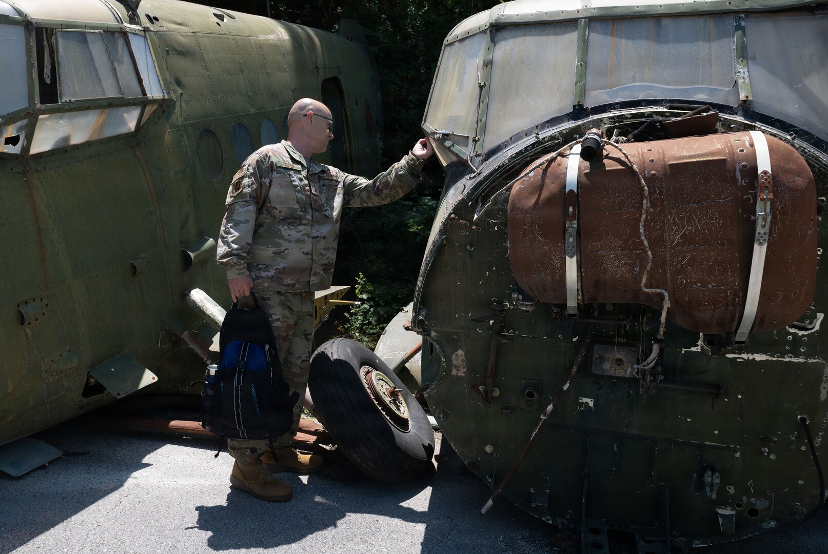 U.S. Air Force Senior Master Sgt. Matthew Foulk, a munitions flight senior enlisted leader assigned to the 177th Fighter Wing, New Jersey Air National Guard, explores a MiG aircraft graveyard during a tour at Kuçovë Air Base, Albania, July 15, 2026.