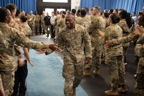 Technical Sergeant selectee walks down and high-fives attendees.