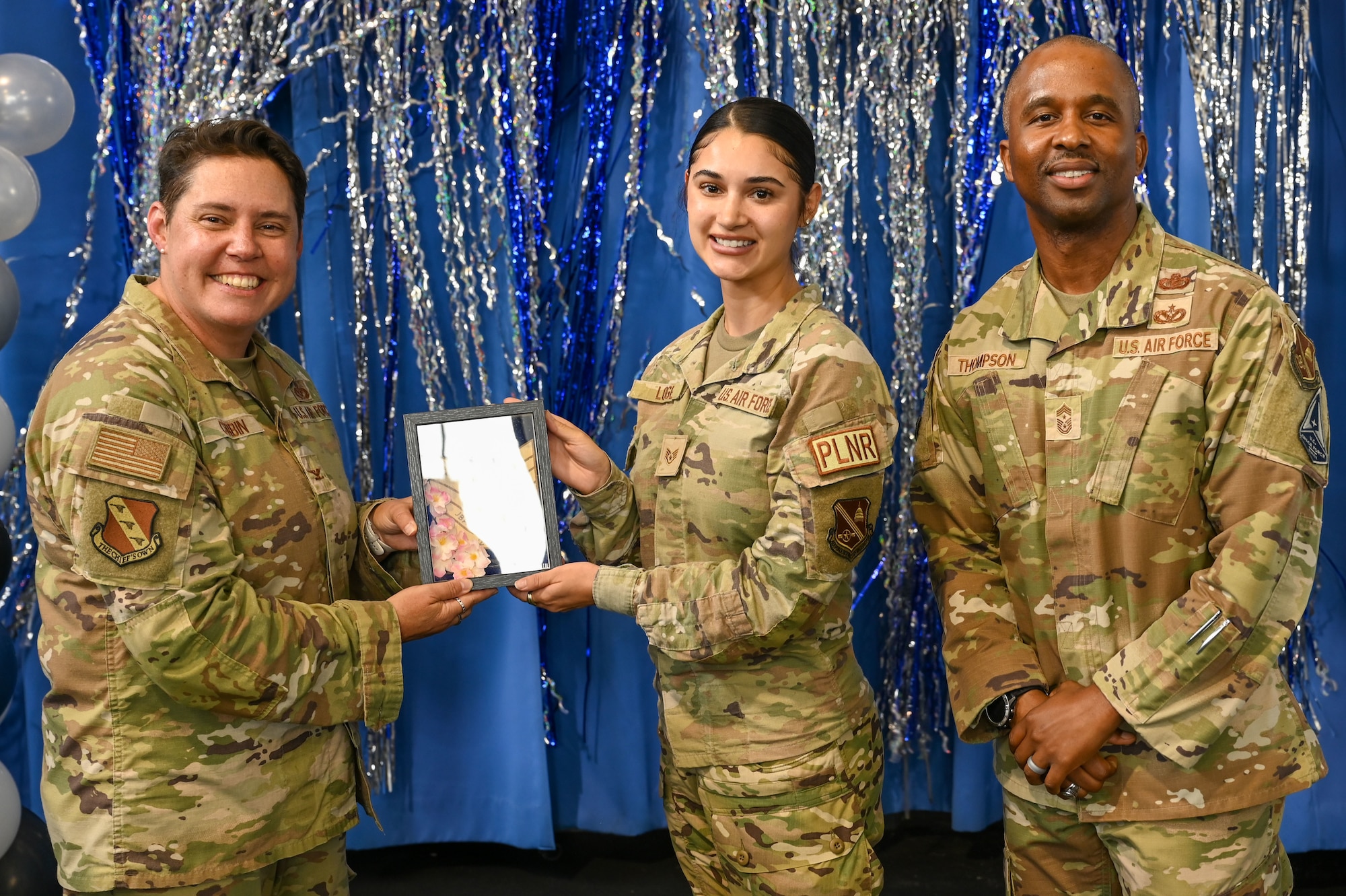 Technical Sergeant selectee poses with deputy commander, left, and command chief, right.