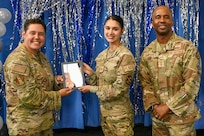 Technical Sergeant selectee poses with deputy commander, left, and command chief, right.