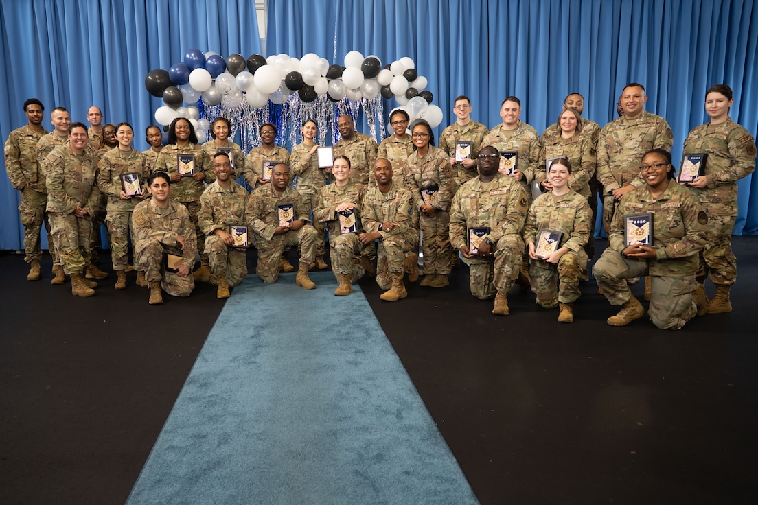 Technical Sergeant selectees pose for a group photo with deputy commander and command chief.