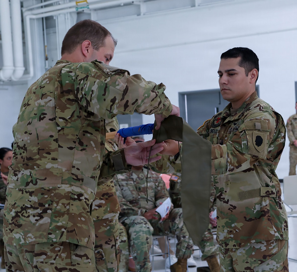 Capt. Jonathan Mercado, right, Commander, Detachment 2, Company G, 1-111th General Aviation Support Battalion, and Sgt. 1st Class Timothy Panatera, acting first sergeant, case the unit's guidon during a ceremony July 12 at the Army Aviation Support Facility in Kankakee.
