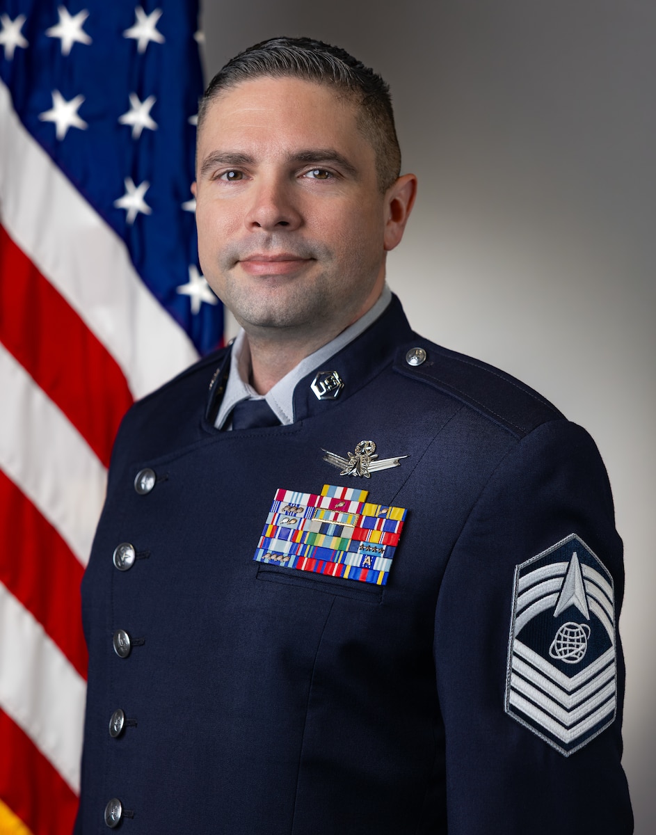 On June 25, 2026 at 9:30 AM, CMSgt Kevin Ryan (Space Force) with MOD had their Head & Shoulders Official Portrait with Straight US & NRO Flag, taken by Sam Bullard.
