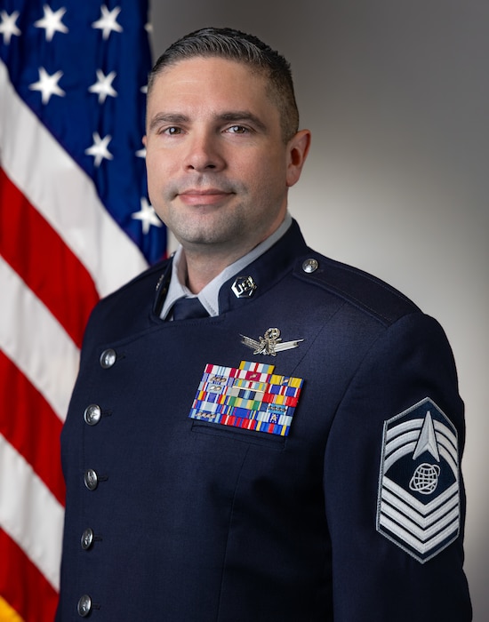 On June 25, 2026 at 9:30 AM, CMSgt Kevin Ryan (Space Force) with MOD had their Head & Shoulders Official Portrait with Straight US & NRO Flag, taken by Sam Bullard.
