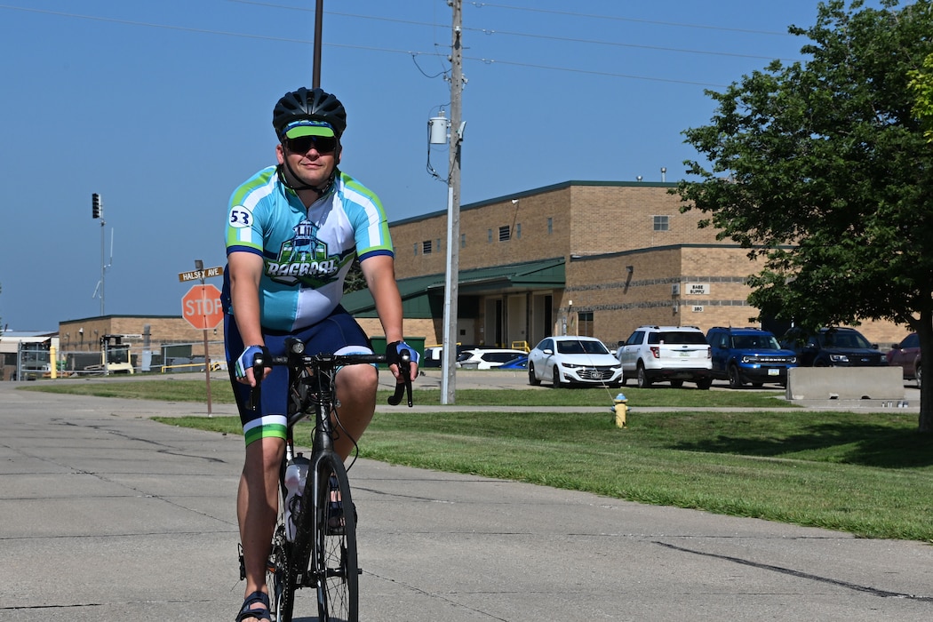 U.S. Air Force Master Sgt. Shane Meendering, 185th Air Refueling Wing Cyber Systems Operations noncommissioned officer in charge, rides his bicycle on a road at the 185th Air Refueling Wing.