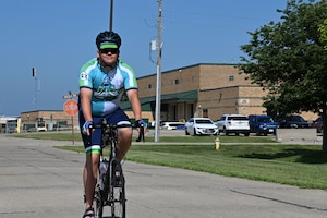 U.S. Air Force Master Sgt. Shane Meendering, 185th Air Refueling Wing Cyber Systems Operations noncommissioned officer in charge, rides his bicycle on a road at the 185th Air Refueling Wing.