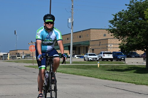 U.S. Air Force Master Sgt. Shane Meendering, 185th Air Refueling Wing Cyber Systems Operations noncommissioned officer in charge, rides his bicycle on a road at the 185th Air Refueling Wing.