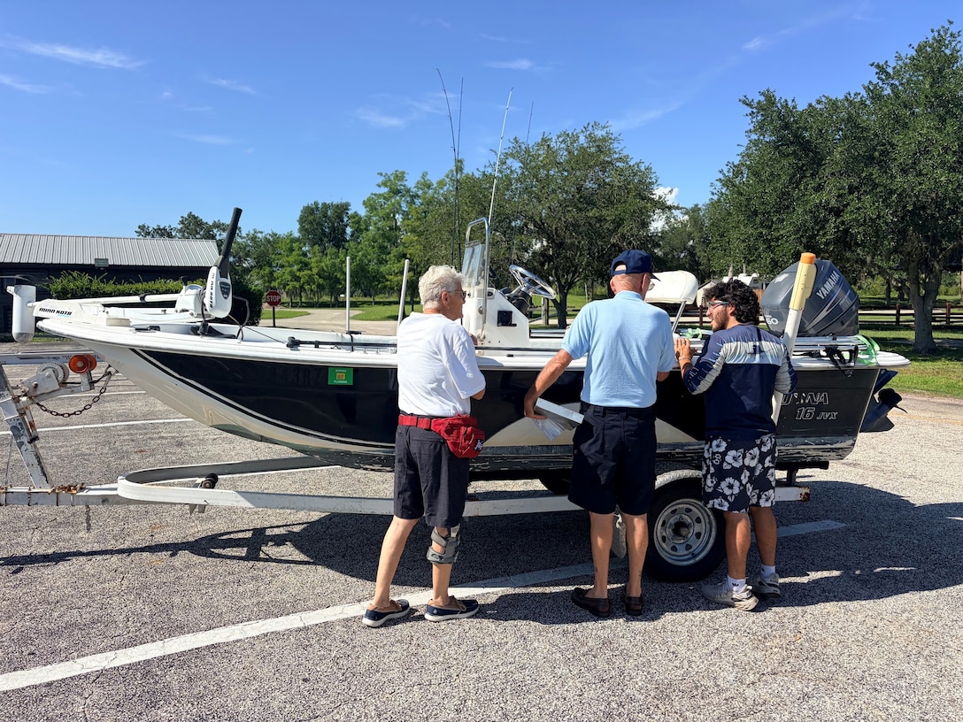 Jim and Sue, volunteers with the U.S. Coast Guard Auxiliary, review required boating safety equipment with a visitor during a free vessel safety examination at the W.P. Franklin South boat ramp in Alva, Florida, July 4, 2026. The event helped educate recreational boaters on safe operating practices before launching onto the water. (U.S. Army photo by Park Ranger Megan Parsons)