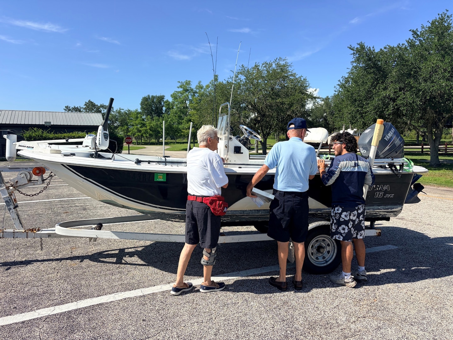 Jim and Sue, volunteers with the U.S. Coast Guard Auxiliary, review required boating safety equipment with a visitor during a free vessel safety examination at the W.P. Franklin South boat ramp in Alva, Florida, July 4, 2026. The event helped educate recreational boaters on safe operating practices before launching onto the water. (U.S. Army photo by Park Ranger Megan Parsons)