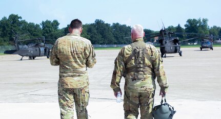 Chief Warrant Officer 5 Herb Stevens, right, State Standardization Pilot and Commander of Army Aviation Support Facility 1 in Kankakee, is joined by Chief Warrant Officer 3 Daniel Wentworth, Illinois Army National Guard Instructor Pilot, on Stevens’ final flight July 16 as an Army Aviator in the Illinois Army National Guard.