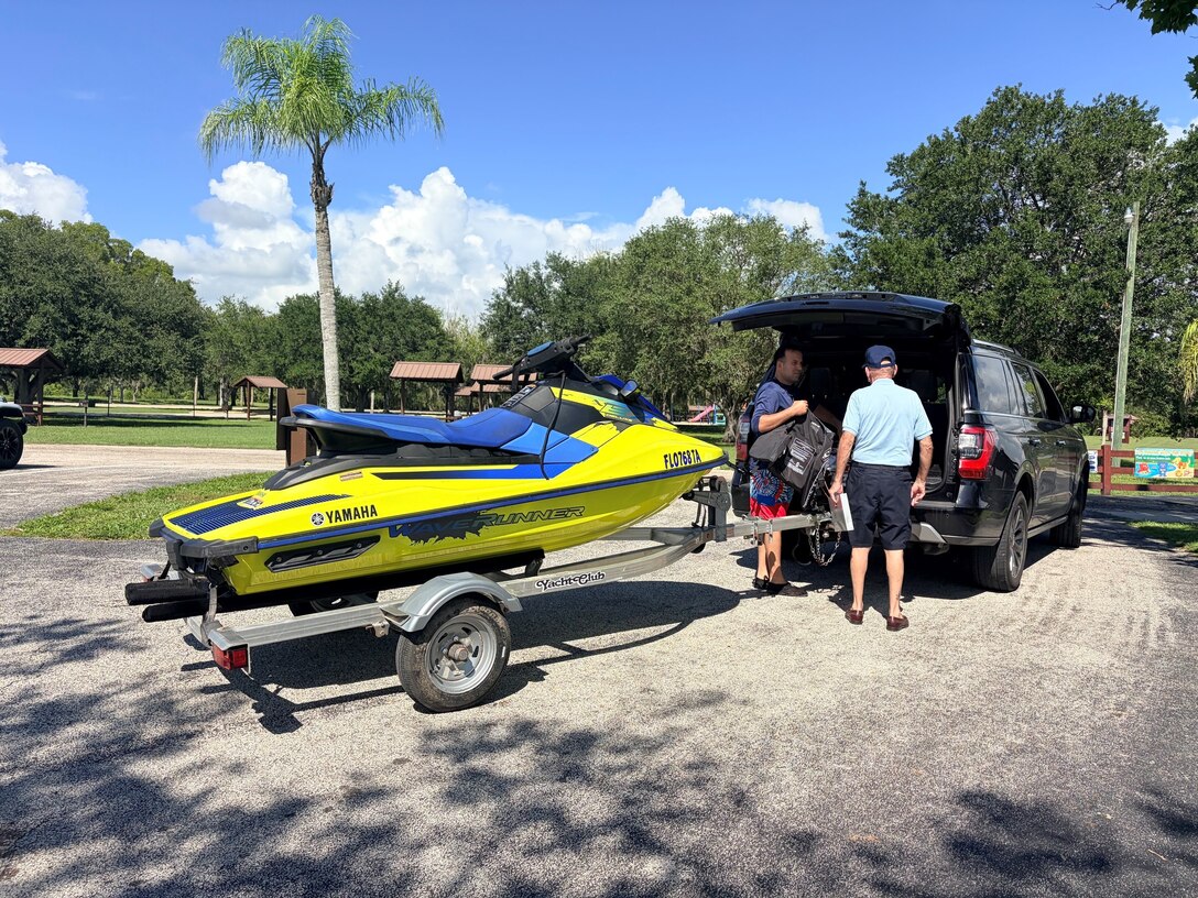 Jim, a volunteer with the U.S. Coast Guard Auxiliary, conducts a voluntary vessel safety examination with a personal watercraft operator during a Fourth of July water safety outreach event at the W.P. Franklin South boat ramp in Alva, Florida, July 4, 2026. The event provided visitors with free safety inspections and boating education before they launched. (U.S. Army photo by Park Ranger Megan Parsons)