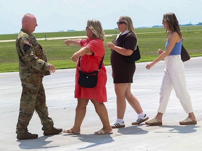 Chief Warrant Officer 5 Herb Stevens, State Standardization Pilot and Commander of Army Aviation Support Facility 1 in Kankakee, is greeted by his family, including wife, Lynette, and daughters Hanna Stevens and Maggie Dhami, following Stevens’ final flight as an Army Aviator July 16 in the Illinois Army National Guard.