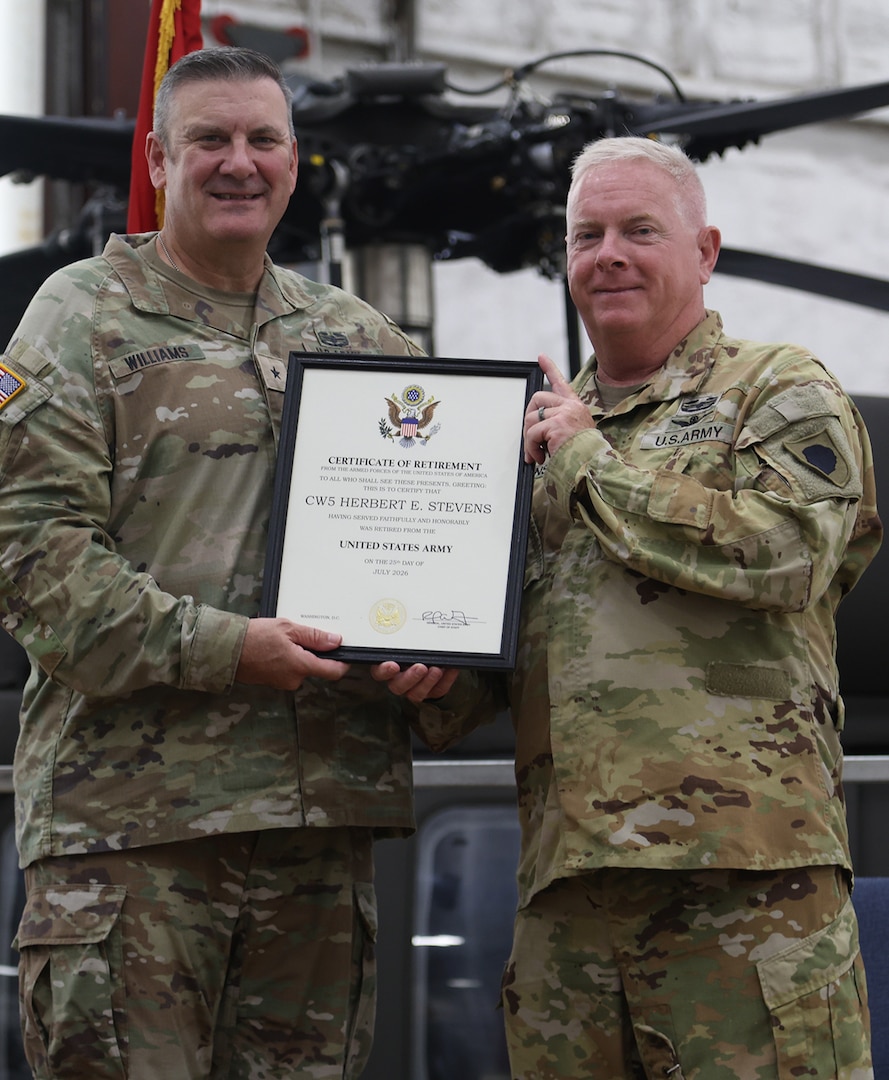 Brig Gen. Lenny Williams, left, Assistant Adjutant General – Army and Commander of the Illinois Army National Guard, presents a certificate of retirement to Chief Warrant Officer 5 Herb Stevens, State Standardization Pilot and Commander of the Army Aviation Support Facility (AASF) 1 in Kankakee, during a retirement ceremony July 16 at AASF 2 in Decatur.