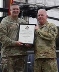 Brig Gen. Lenny Williams, left, Assistant Adjutant General – Army and Commander of the Illinois Army National Guard, presents a certificate of retirement to Chief Warrant Officer 5 Herb Stevens, State Standardization Pilot and Commander of the Army Aviation Support Facility (AASF) 1 in Kankakee, during a retirement ceremony July 16 at AASF 2 in Decatur.