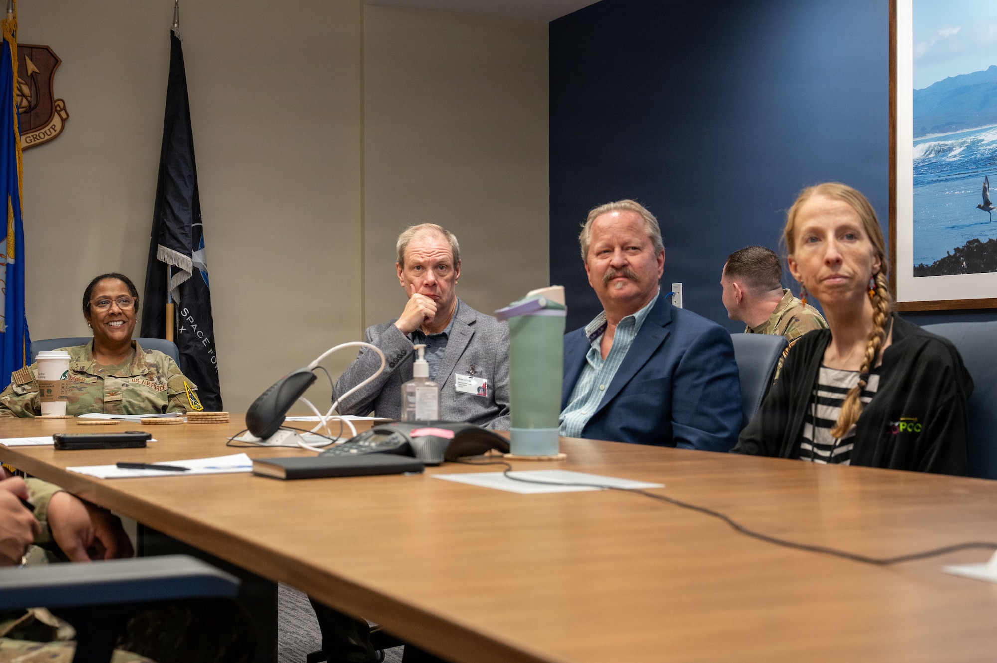 a group of people sit at a conference table