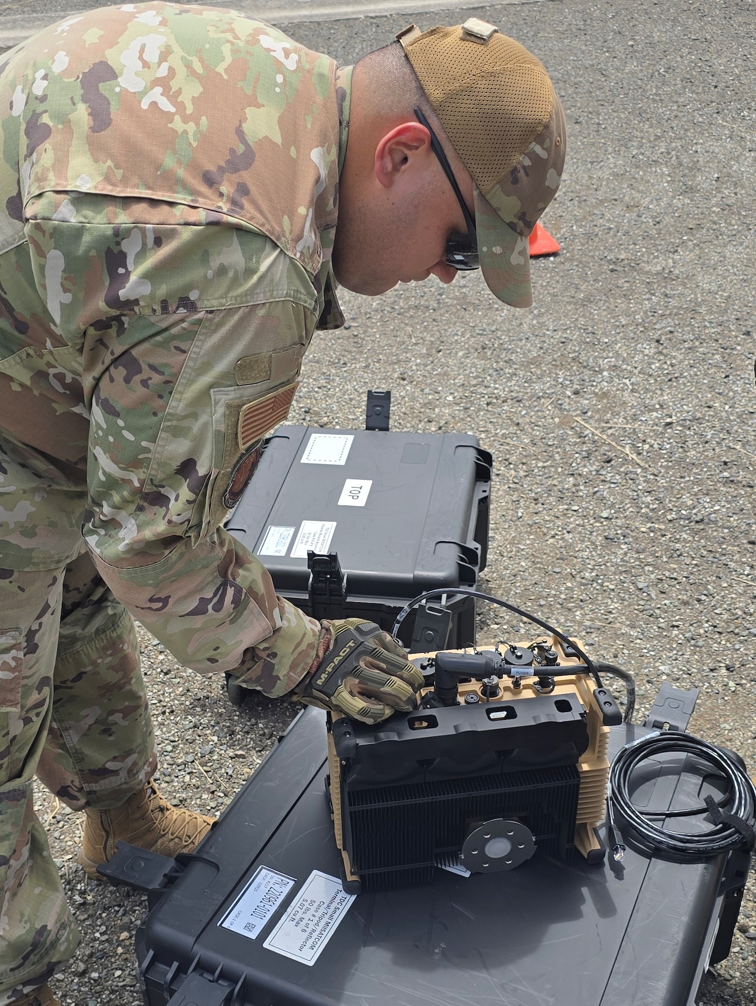 U.S. Air Force Senior Airman Geraldo Ortiz, radio frequency transmissions systems specialist, 156th Combat Communication Squadron, Puerto Rico Air National Guard, assembles a terminal modem during exercise FUNKY BUSINESS at the 130th Engineer Battalion, Vega Baja, Puerto Rico, June 4, 2026. The exercise tested Airmen's ability to rapidly establish expeditionary communications and sustain mission readiness through realistic deployment operations and disciplined logistical procedures. (U.S. Air National Guard courtesy photo)