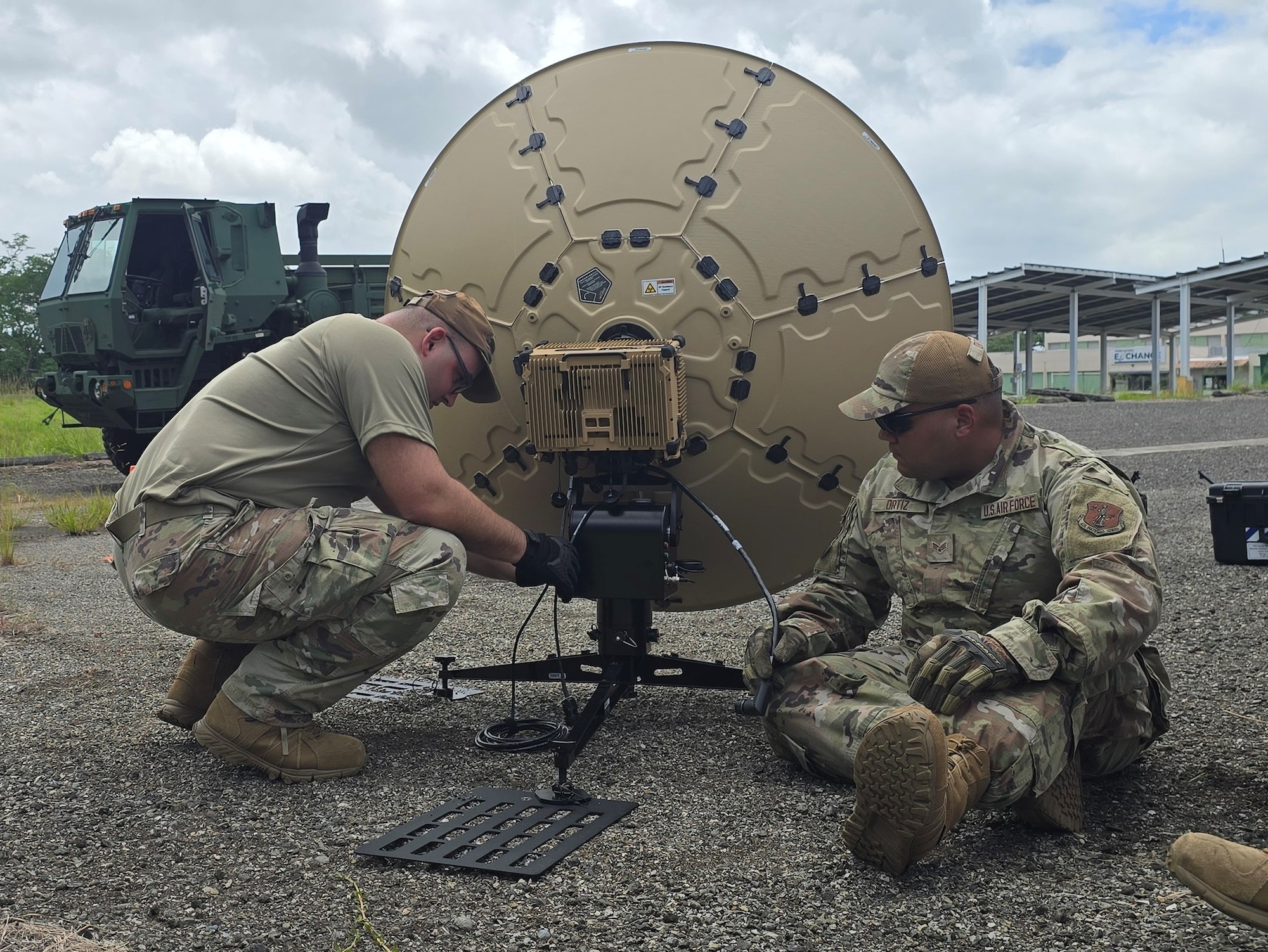 U.S. Airmen with the 156th Combat Communication Squadron, Puerto Rico Air National Guard, assemble a Tampa microwave 1.3M terminal during exercise FUNKY BUSINESS at the 130th Engineer Battalion, Vega Baja, Puerto Rico, June 4, 2026. The exercise tested Airmen's ability to rapidly establish expeditionary communications and sustain mission readiness through realistic deployment operations and disciplined logistical procedures. (U.S. Air National Guard courtesy photo)