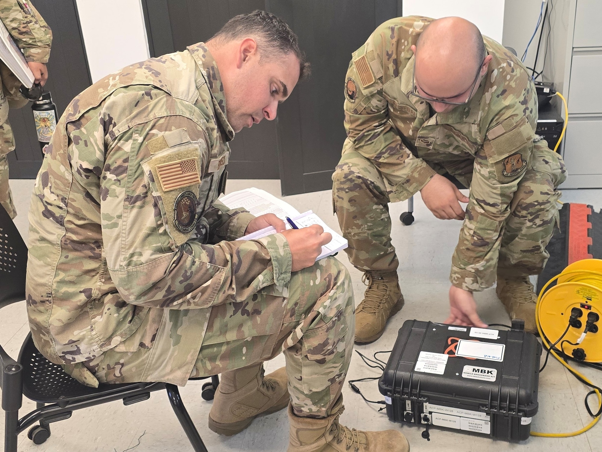From left, U.S. Air Force Tech. Sgt. Omar Berdecia, a radio frequency transmission systems specialist, and Senior Airman Christian Rivera, a network systems operations specialist, prepare a mobile broadband kit for deployment, during exercise FUNKY BUSINESS at Punta Salinas Air National Guard Station, Toa Baja, Puerto Rico, June 3, 2026. The exercise tested Airmen's ability to rapidly establish expeditionary communications and sustain mission readiness through realistic deployment operations and disciplined logistical procedures. (U.S. Air National Guard courtesy photo)