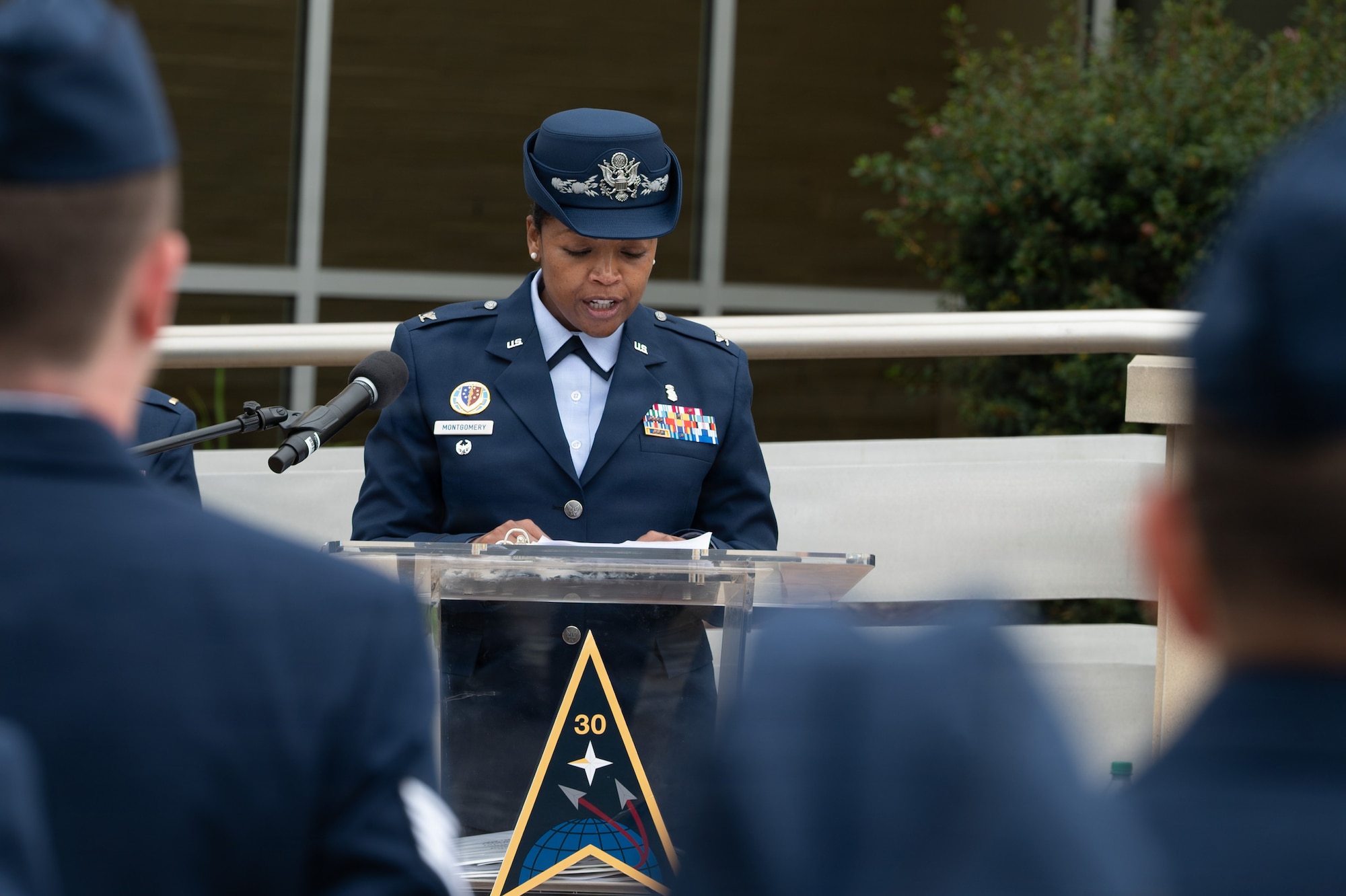 A person stands and speaks behind a podium