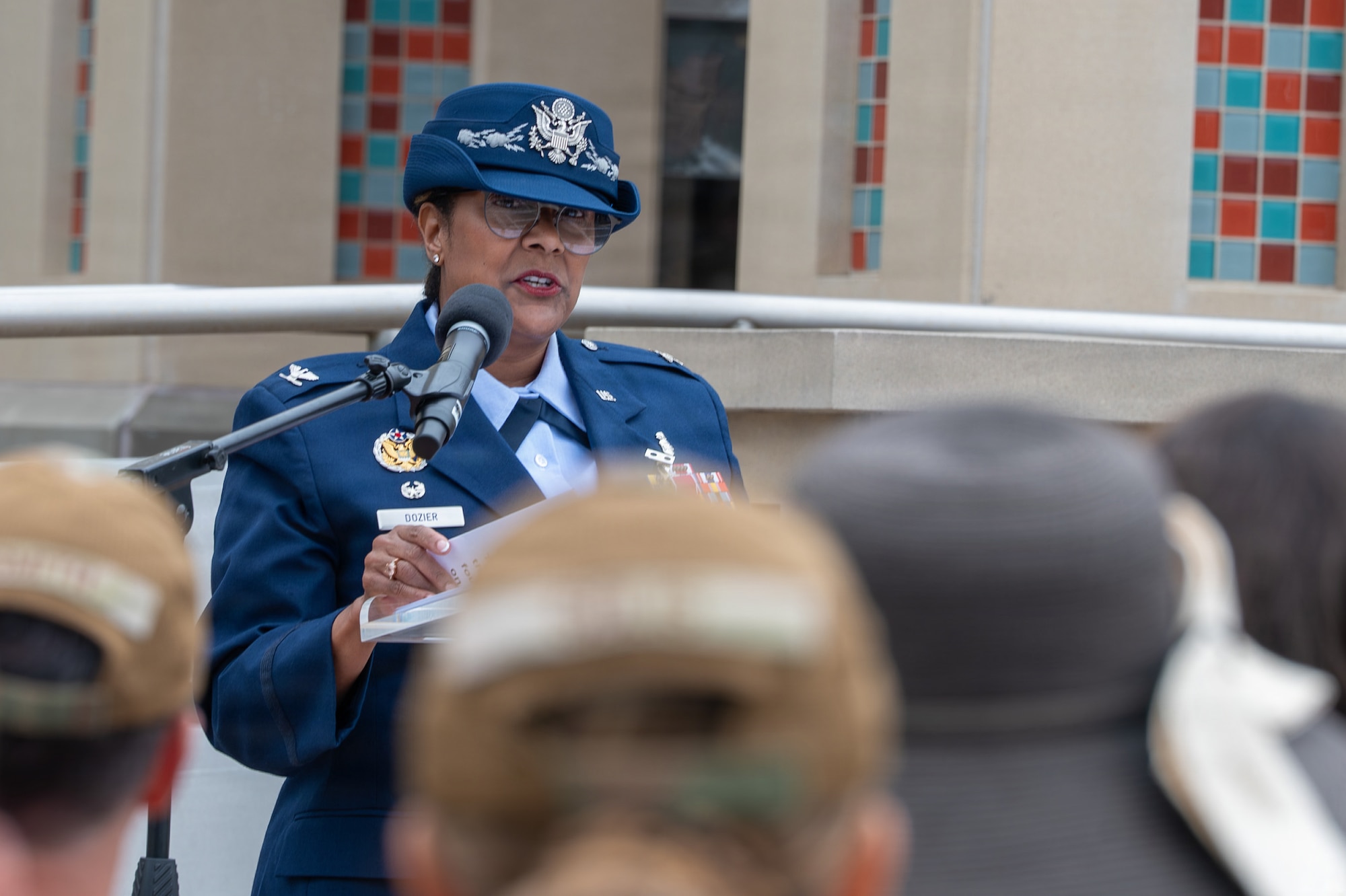 A person stands and speaks behind a podium