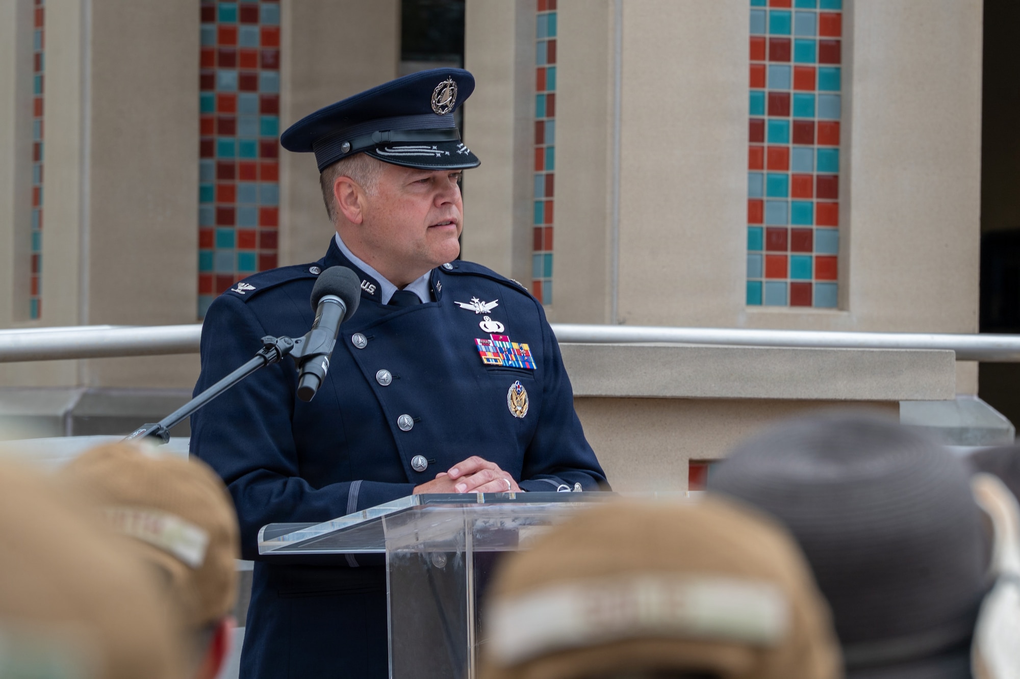 A person stands behind a podium and speaks