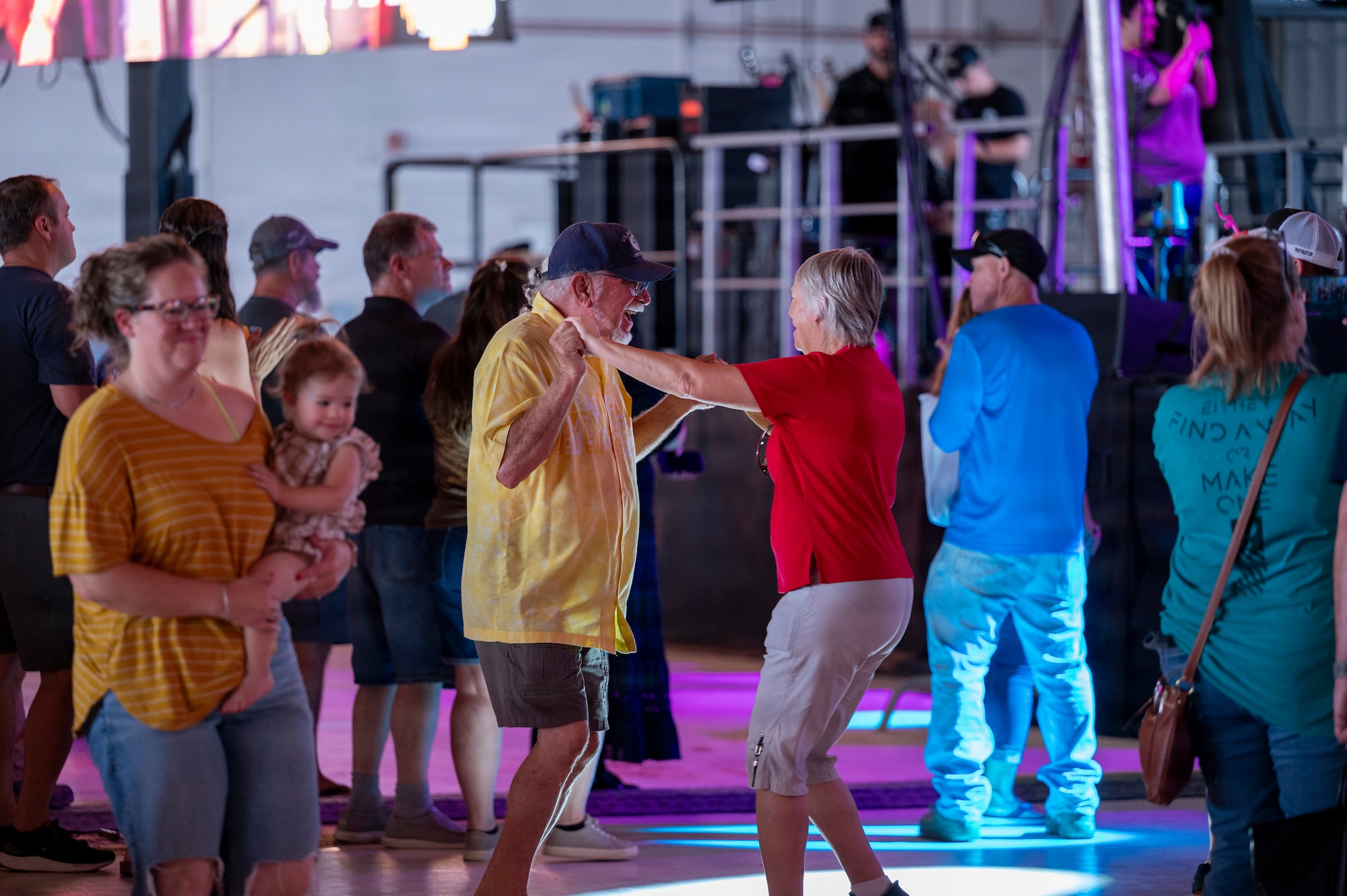 Attendees dance and celebrate during a concert at Holloman Air Force Base, New Mexico, July 12, 2026. Through the Gary Sinise Foundation, Sinise has helped raise over $300 million to support disabled veterans, first responders and their families. (U.S. Air Force photo by Senior Airman Michelle Ferrari)