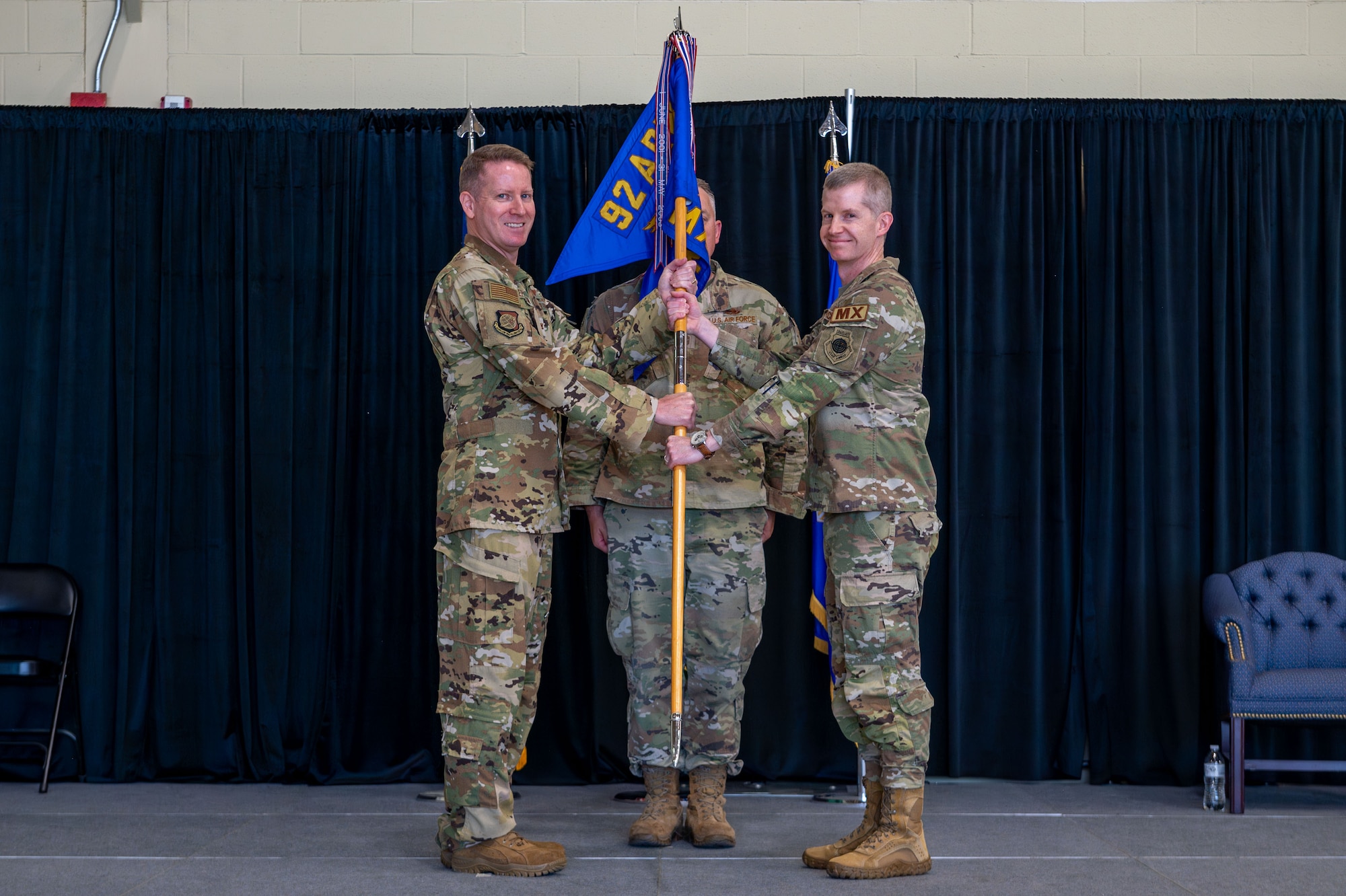 An Airman passes the guidon.