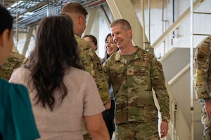 Airmen exchange handshakes.