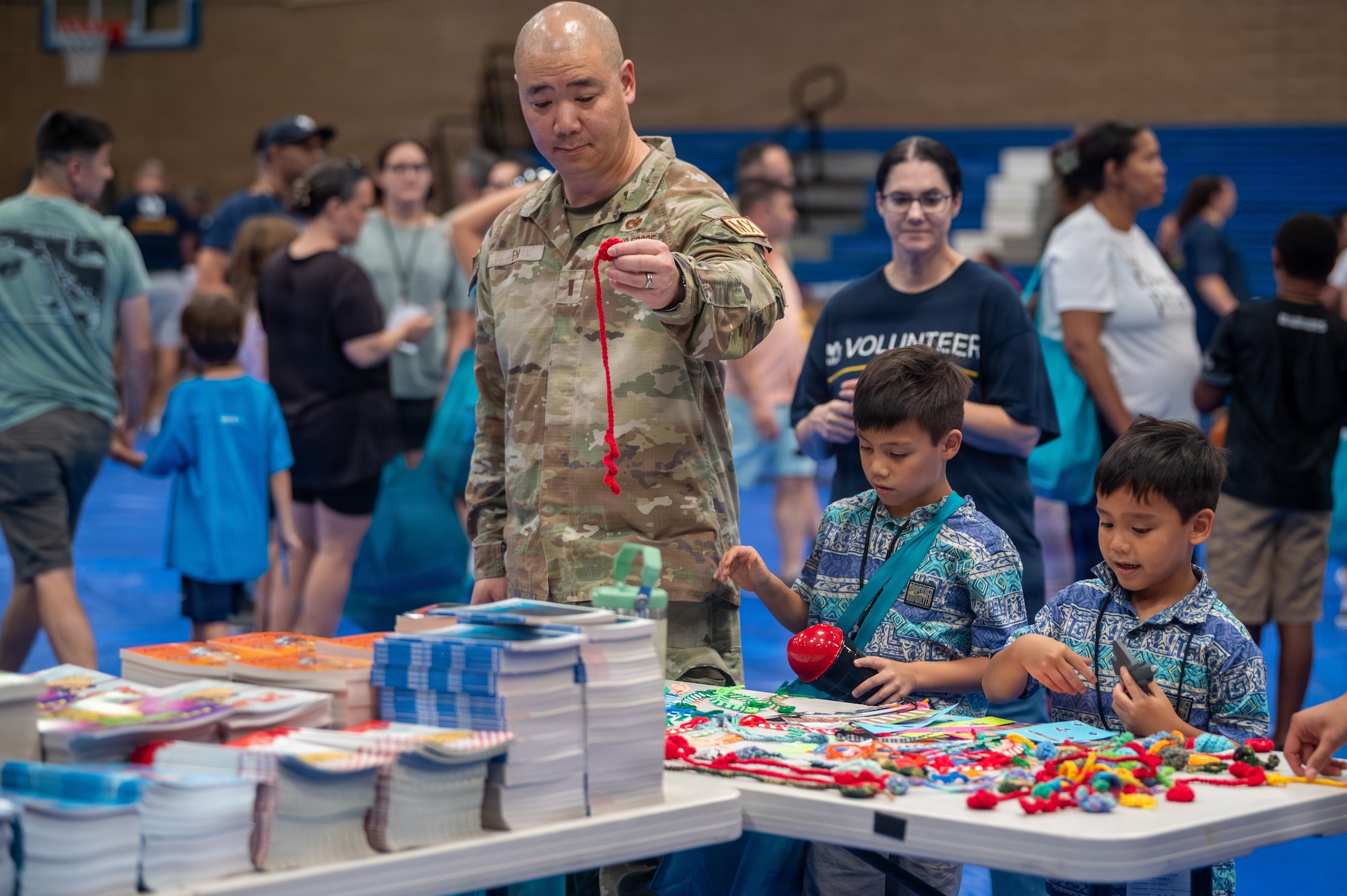 U.S. Air Force 2nd Lt. Alexander En, a 56th Equipment Maintenance Squadron aerospace ground equipment flight commander, helps pick out school supplies during the Back to School Bash held at Luke Air Force Base, Arizona, July 14, 2026.
