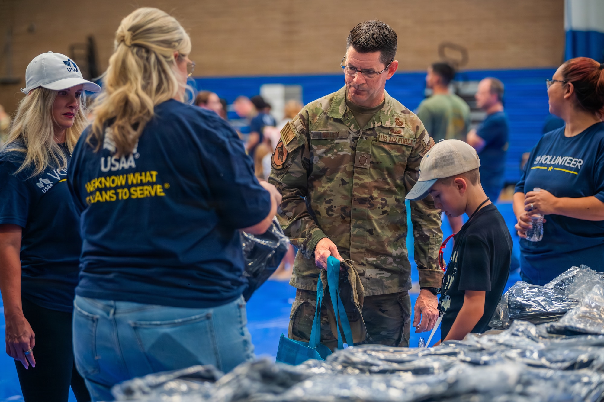 Volunteers assist a military family during the Back to School Bash held at Luke Air Force Base, Arizona, July 14, 2026.