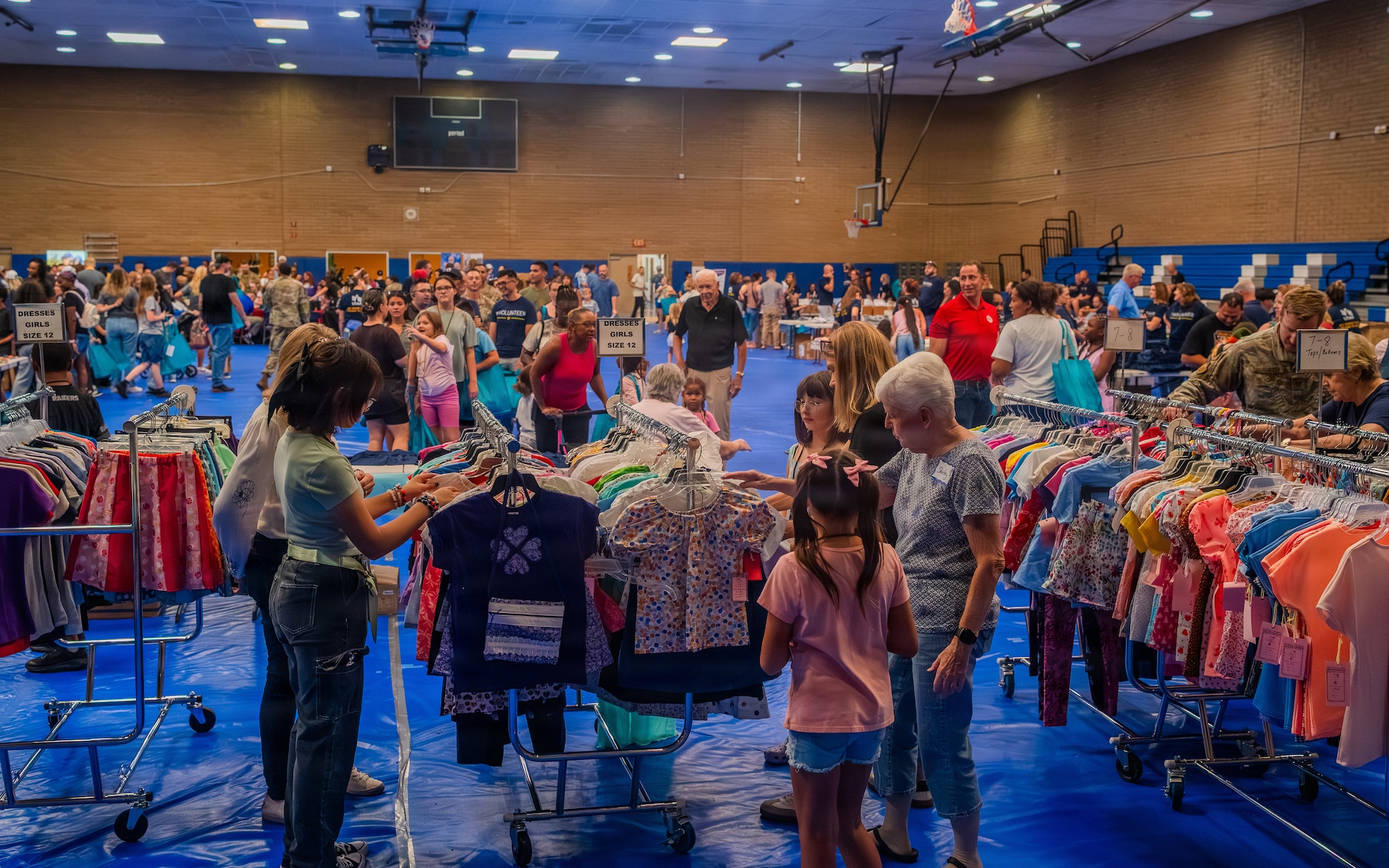 Volunteers help military families pick first day of school outfits during the Back to School Bash held at Luke Air Force Base, Arizona, July 14, 2026.