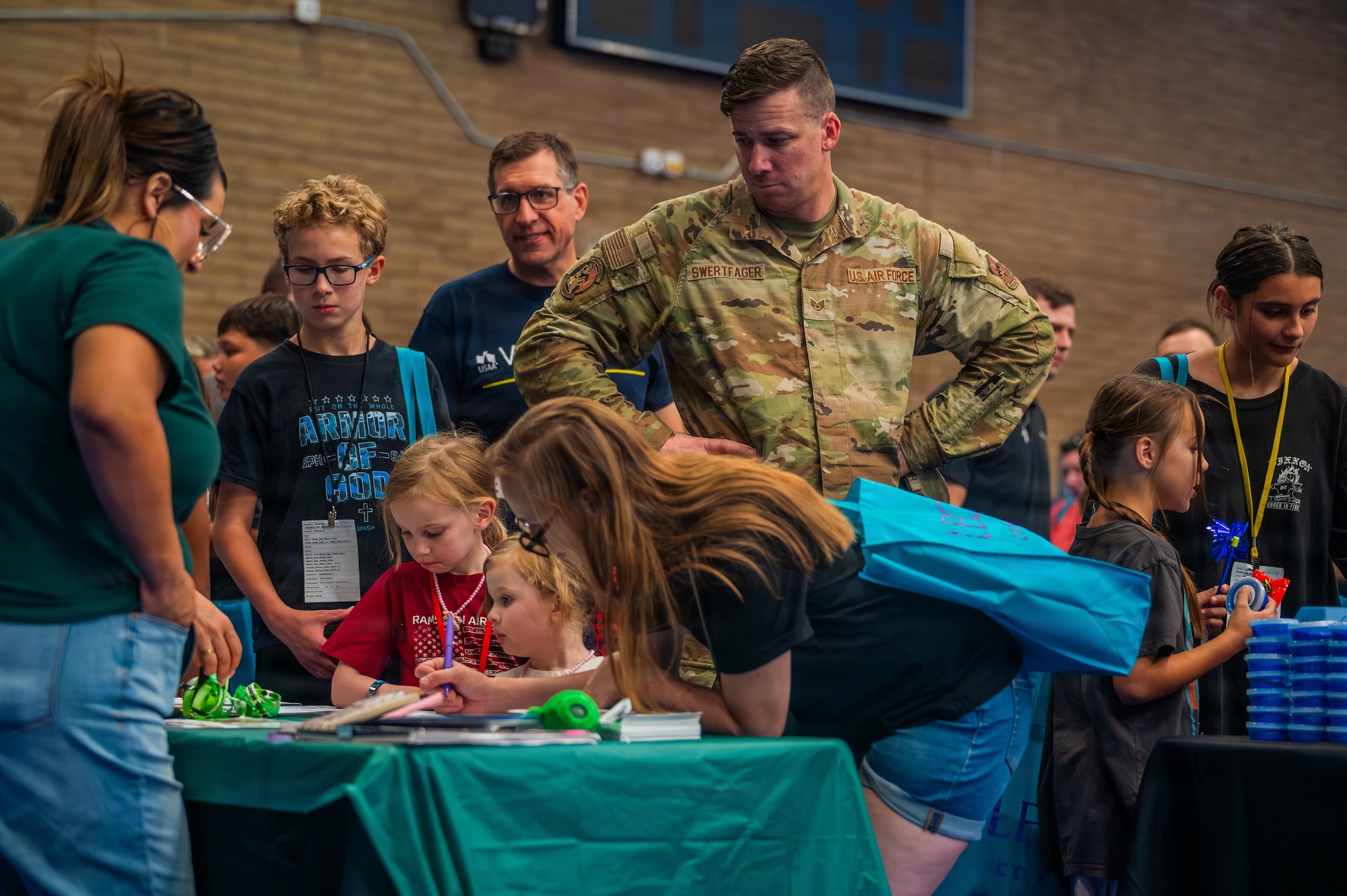 U.S. Air Force Staff Sgt. Jacob Swertfager, a 56th Civil Engineer Squadron water and fuels systems maintenance specialist, looks at chapel and community-based resources during the Back to School Bash held at Luke Air Force Base, Arizona, July 14, 2026.