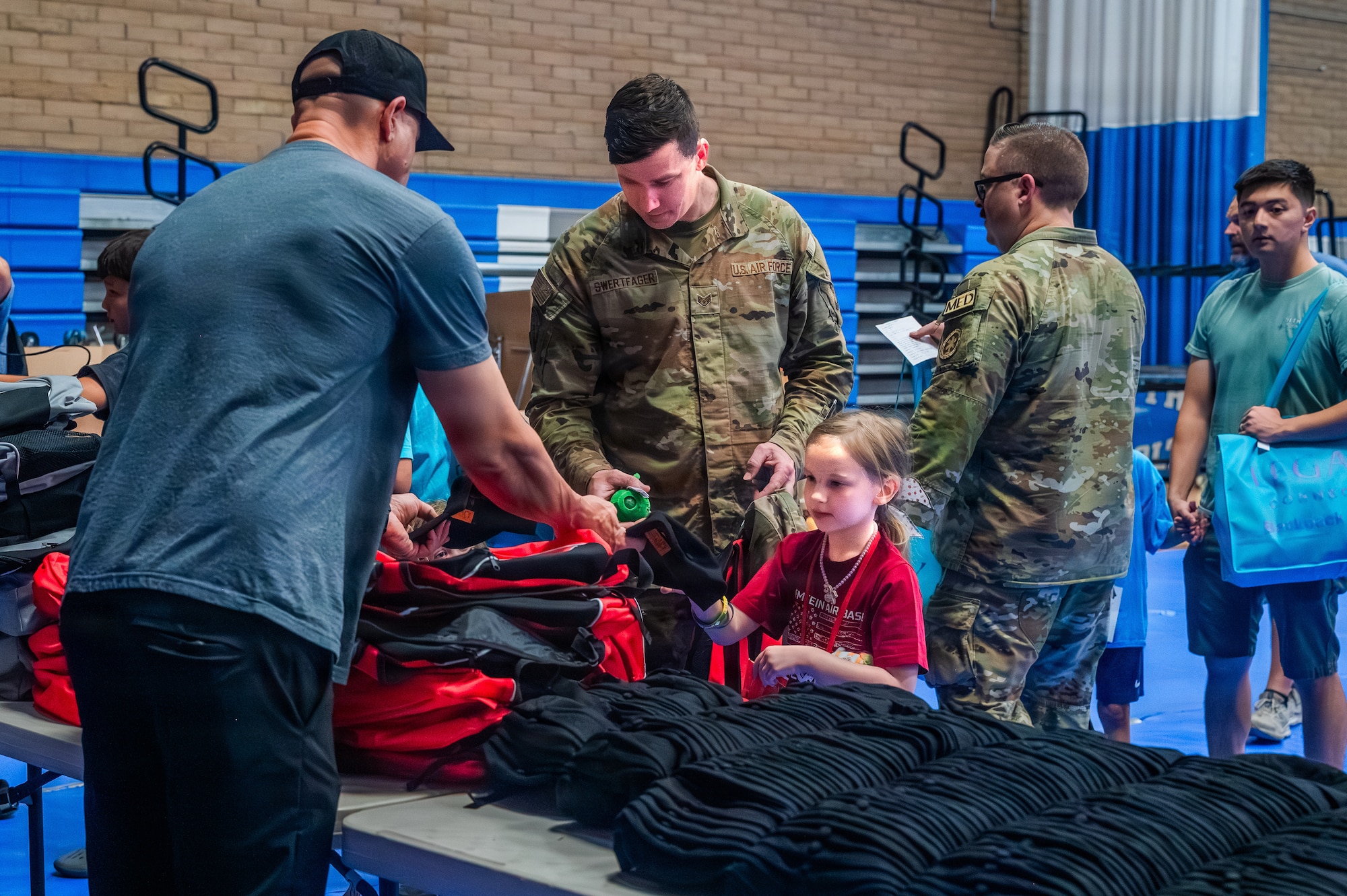 U.S. Air Force Staff Sgt. Jacob Swertfager, a 56th Civil Engineer Squadron water and fuels systems maintenance specialist, browses resilience gear during the Back to School Bash held at Luke Air Force Base, Arizona, July 14, 2026.