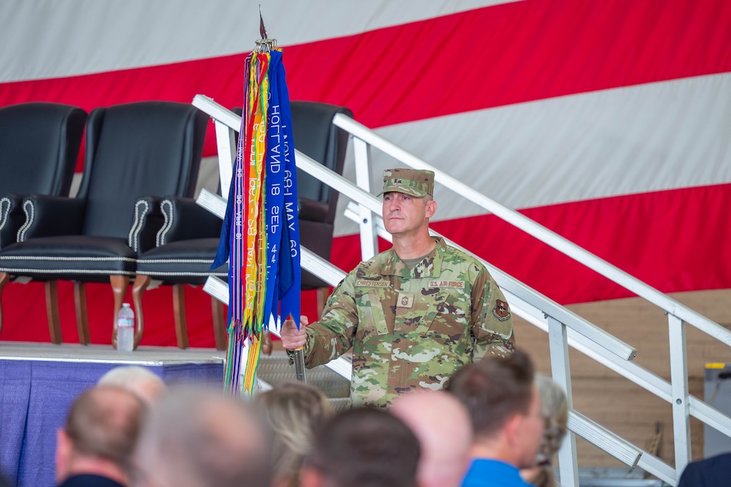 A U.S. Airman holds a guidon during a change of command ceremony.