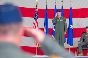 A U.S. Airman renders his first salute while assuming command of a Fighter Wing.