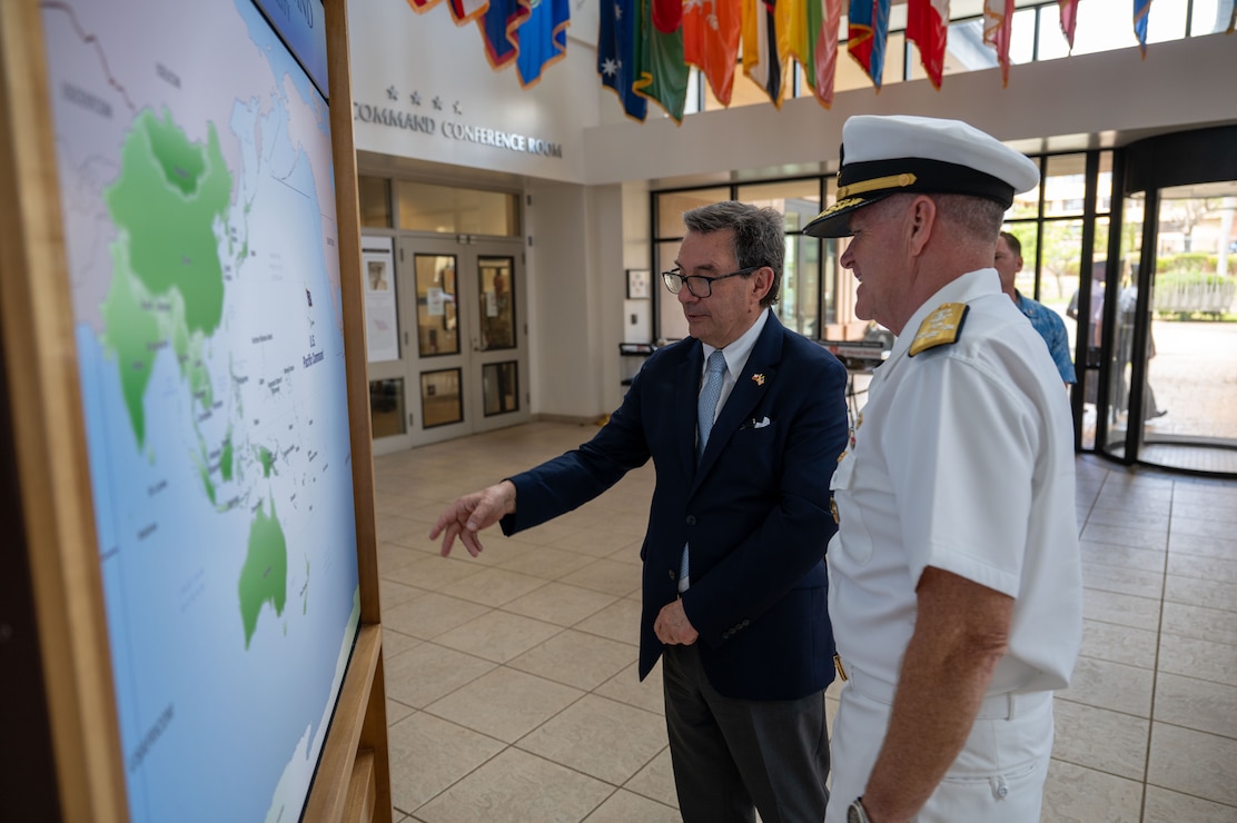 Adm. Samuel J. Paparo, right, commander of U.S. Pacific Command, and His Excellency Fernando Barros, left, Minister of National Defense of Chile, discuss an area of responsibility displayed during a visit to the US PACOM headquarters building at Camp H.M. Smith, Hawaii, July 17, 2026.
