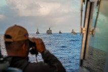 A Sailor assigned to the Philippine Navy Miguel Malvar-class guided-missile frigate BRP Miguel Malvar (FFG06) overlooks as the USNS Guadalupe comes alongside for a replenishment-at-sea in the Pacific Ocean during Exercise Rim of the Pacific 2026, July 11, 2026.