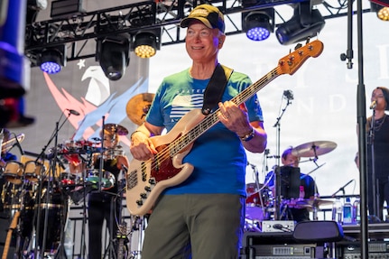 Gary Sinise, actor and founder of the Gary Sinise Foundation, plays the guitar with the Lt. Dan Band during a concert at Holloman Air Force Base, New Mexico, July 12, 2026. Gary Sinise played the role of Lt. Dan in the 1994 film “Forrest Gump” and founded the band in 2003 to honor service members, veterans, first responders and their families through live music. (U.S. Air Force photo by Senior Airman Michelle Ferrari)