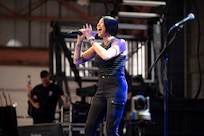 Molly Callinan, Lt. Dan Band vocalist, sings during a concert at Holloman Air Force Base, New Mexico, July 12, 2026. Following the 9/11 attacks, Gary Sinise formed the Lt. Dan Band with musician Kimo Williams in Chicago of 2003 to boost military morale and raise millions of dollars for disabled veterans. (U.S. Air Force photo by Senior Airman Michelle Ferrari)
