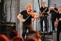 Dan Myers, violin player and vocalist of the Lt. Dan Band, performs at Holloman Air Force Base, New Mexico, July 12, 2026. The concert provided an evening of live entertainment promoting morale and honoring service members and their families. (U.S. Air Force photo by Senior Airman Michelle Ferrari)