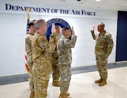 Service members reciting the Oath of Office.