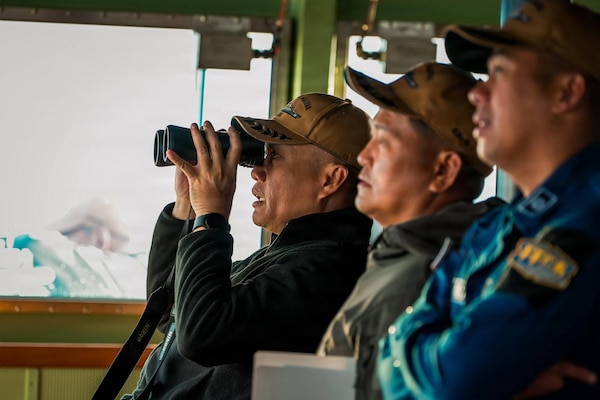 The key officers assigned to the Philippine Navy Miguel Malvar-class guided-missile frigate BRP Miguel Malvar (FFG06) overlook as the USNS Guadalupe comes alongside for a replenishment-at-sea in the Pacific Ocean during Exercise Rim of the Pacific 2026, July 11, 2026.